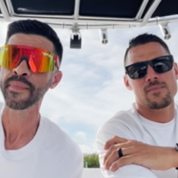keith daubmann and bryce holbert wearing sunglasses on a boat.