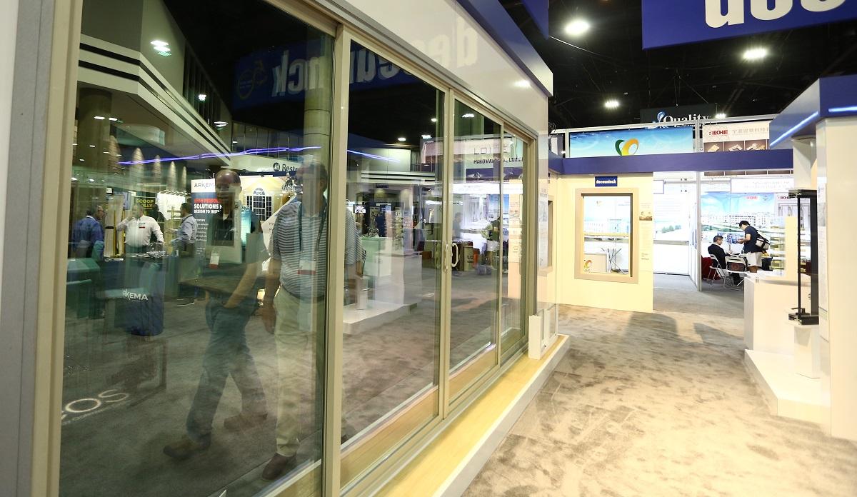 window display at GlassBuild with people walking in the aisle