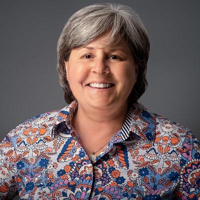 Deb Callahan. A woman with short gray hair, smiling.
