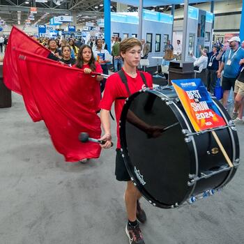 student drummer and color guard at GlassBuild 2024