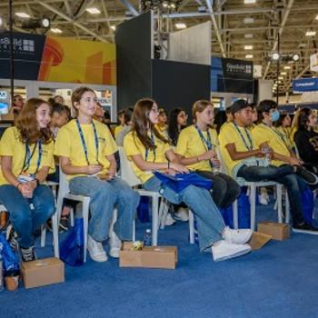 students listen to a session on the GlassBuild Main Stage