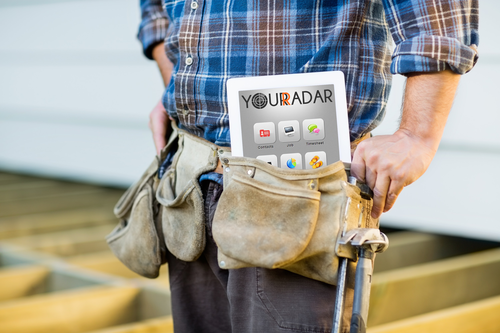 worker with toolbelt containing tablet